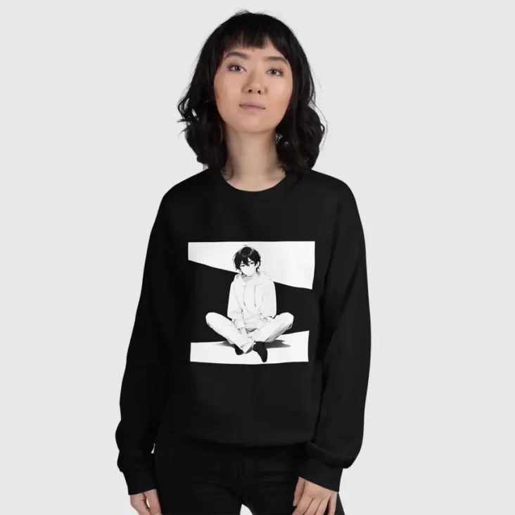 A woman wearing a black sweatshirt with a manga design of an anime boy sitting