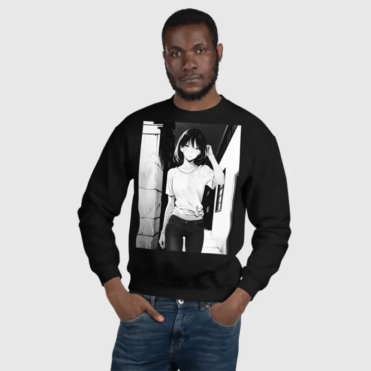 A man with his hands in his pockets wearing a black sweatshirt with a manga design of an anime girl in the neighborhood