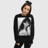 A woman wearing a black sweatshirt with a manga design of a long hair anime girl