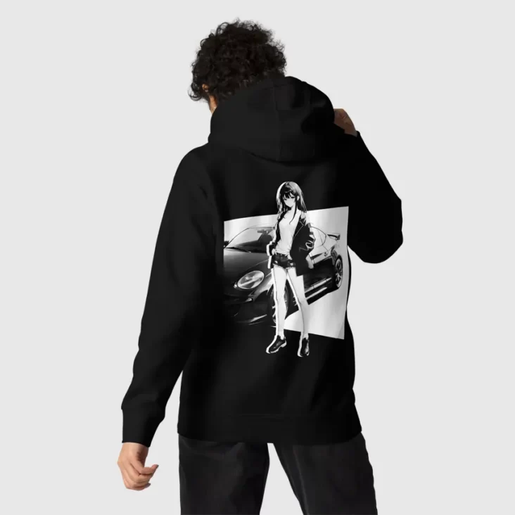 A man putting on the hood of a black hoodie with a manga design of an anime girl and car