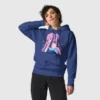 A woman wearing a blue hoodie with a design of a pink hair anime girl