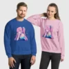 A man and woman wearing blue and pink sweatshirts with a design of a pink hair anime girl