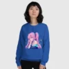 A woman wearing a blue sweatshirt with a design of a pink hair anime girl