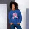 A woman with her hands in her pockets wearing a blue sweatshirt with a design of a pink hair anime girl